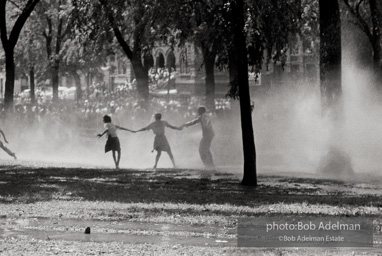 Demonstrators hold onto each other to face the spray, Kelly Ingram Park, Birmingham 1963.