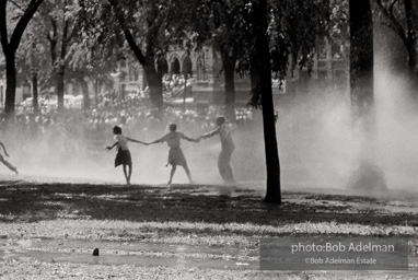 Demonstrators hold onto each other to face the spray, Kelly Ingram Park, Birmingham 1963. Demonstrators hold onto each other to face the spray, Kelly Ingram Park, Birmingham 1963.