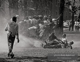 Demonstrators hold onto each other to face the spray, Kelly Ingram Park, Birmingham 1963