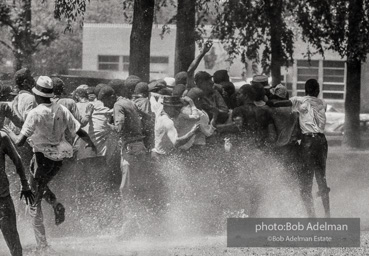 Demonstrators hold onto each other to face the spray, Kelly Ingram Park, Birmingham 1963