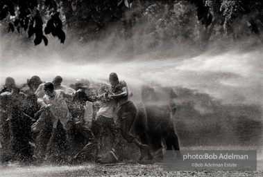 Unified resistance, Kelly Ingram Park, Birmingham 1963
Demonstrators quickly learned that by huddling together they could use their combined strength to withstand the blast of the fire hoses. Unified resistance, Kelly Ingram Park, Birmingham 1963
Demonstrators quickly learned that by huddling together they could use their combined strength to withstand the blast of the fire hoses.