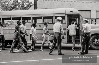 Arrested protestors are loaded onto a bus and taken to a detention center. Birmingham, AL, 1963.