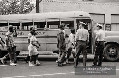 Arrested protestors are loaded onto a bus and taken to a detention center. Birmingham, AL, 1963.