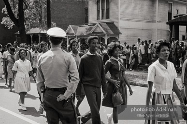 Young protestors, after meeting at the 16th Street Baptist Church, begin their Children's Crusade and are soon arrested and bussed to a detention center. Birmingham, AL, 1963.