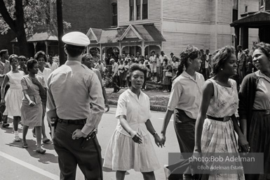 Young protestors, after meeting at the 16th Street Baptist Church, begin their Children's Crusade and are soon arrested and bussed to a detention center. Birmingham, AL, 1963.