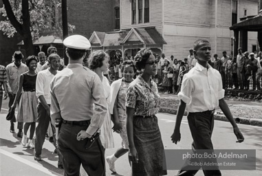 Young protestors, after meeting at the 16th Street Baptist Church, begin their Children's Crusade and are soon arrested and bussed to a detention center. Birmingham, AL, 1963.