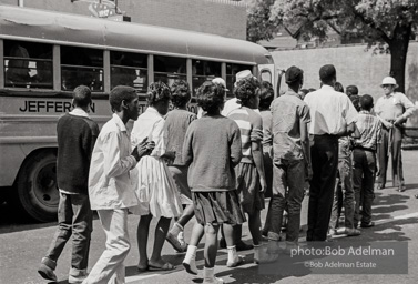 Arrested protestors are loaded onto a bus and taken to a detention center. Birmingham, AL, 1963.