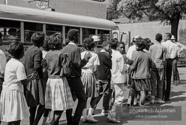 Arrested protestors are loaded onto a bus and taken to a detention center. Birmingham, AL, 1963.