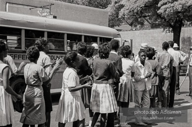 Arrested protestors are loaded onto a bus and taken to a detention center. Birmingham, AL, 1963.