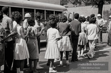 Arrested protestors are loaded onto a bus and taken to a detention center. Birmingham, AL, 1963.