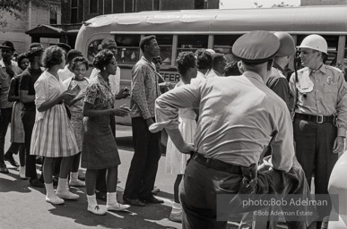 Arrested protestors are loaded onto a bus and taken to a detention center. Birmingham, AL, 1963.