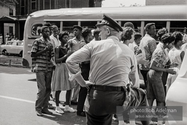 Arrested protestors are loaded onto a bus and taken to a detention center. Birmingham, AL, 1963.