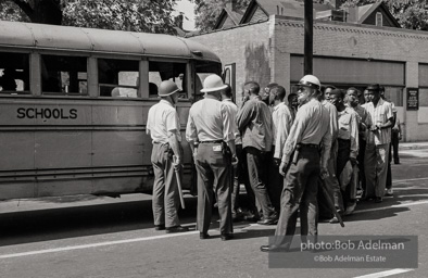 Arrested protestors are loaded onto a bus and taken to a detention center. Birmingham, AL, 1963.