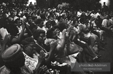 The audience responds as Martin Luther King and Ralph Abernathy speak at the 16th Stret Baptist Church. Birmingham Alabama, 1963.