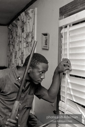 Neighbor of Rev. Carter who's come to help protect him after Rev. Carter registered to vote. West Feliciana Parish, Louisiana. 1964