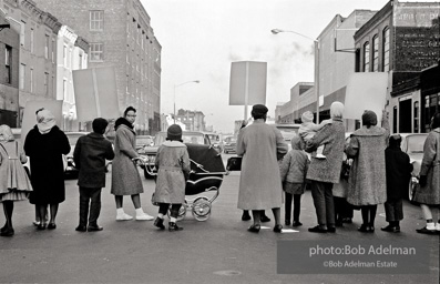 We shall not be moved. Safety first: Parents and children respond to a wave of accidents by blocking their street and demanding the installation of a traffic light,  Brooklyn,  New York City. January 17, 1963.