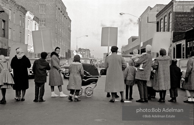 We shall not be moved. Safety first: Parents and children respond to a wave of accidents by blocking their street and demanding the installation of a traffic light,  Brooklyn,  New York City. January 17, 1963.