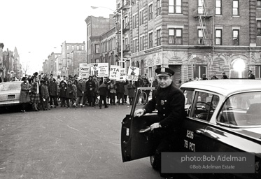 We shall not be moved. Safety first: Parents and children respond to a wave of accidents by blocking their street and demanding the installation of a traffic light,  Brooklyn,  New York City. January 17, 1963.