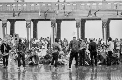 Singing in the rain,  Atlantic City, New Jersey. 1964

“Just back from the horrific and heroic Freedom Summer campaign of 1964, where they were attempting to register black voters in the Deep South, students sang and protested outside the Democratic Party National Convention in Atlantic City. They were asking for color-blind voting laws for delegates and voters alike.”