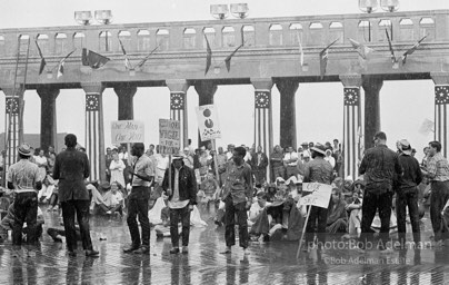 Singing in the rain,  Atlantic City, New Jersey. 1964

“Just back from the horrific and heroic Freedom Summer campaign of 1964, where they were attempting to register black voters in the Deep South, students sang and protested outside the Democratic Party National Convention in Atlantic City. They were asking for color-blind voting laws for delegates and voters alike.”