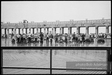 Singing in the rain,  Atlantic City, New Jersey. 1964

“Just back from the horrific and heroic Freedom Summer campaign of 1964, where they were attempting to register black voters in the Deep South, students sang and protested outside the Democratic Party National Convention in Atlantic City. They were asking for color-blind voting laws for delegates and voters alike.”