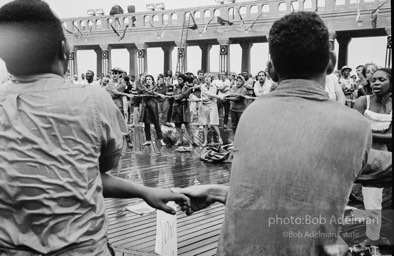 Singing in the rain,  Atlantic City, New Jersey. 1964

“Just back from the horrific and heroic Freedom Summer campaign of 1964, where they were attempting to register black voters in the Deep South, students sang and protested outside the Democratic Party National Convention in Atlantic City. They were asking for color-blind voting laws for delegates and voters alike.”