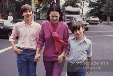 Gloria Vanderbilt walks on the upper east side between her two sons, Carter Vanderbilt Cooper  and Anderson Cooper. New York City, 1980.