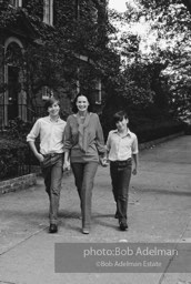Gloria Vanderbilt walks on the upper east side between her two sons, Carter Vanderbilt Cooper  and Anderson Cooper. New York City, 1980.