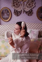 Gloria Vanderbilt brushes her hair in the boudoir of her New York City apartment, 1980.