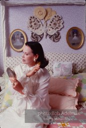 Gloria Vanderbilt brushes her hair in the boudoir of her New York City apartment, 1980.