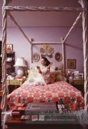 Gloria Vanderbilt brushes her hair in the boudoir of her New York City apartment, 1980.