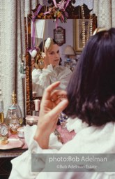 Gloria Vanderbilt brushes her hair in the boudoir of her New York City apartment, 1980.