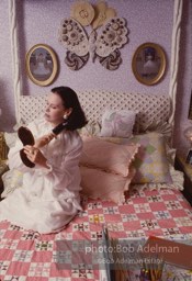 Gloria Vanderbilt brushes her hair in the boudoir of her New York City apartment, 1980.