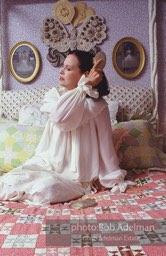 Gloria Vanderbilt brushes her hair in the boudoir of her New York City apartment, 1980.