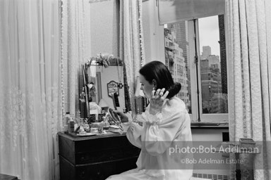Gloria Vanderbilt brushes her hair in the boudoir of her New York City apartment, 1980.