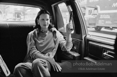 Gloria Vanderbilt goes to work in a chauffer driven limosine. New York City, 1980.