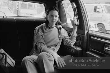 Gloria Vanderbilt goes to work in a chauffer driven limosine. New York City, 1980.