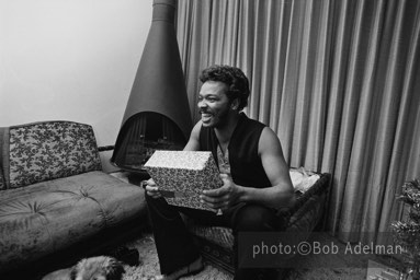Silky opens a present. - New York City, 1970. photo:©Bob Adelman. From the book Gentleman of Leisure by Susan Hall and Bob Adelman.