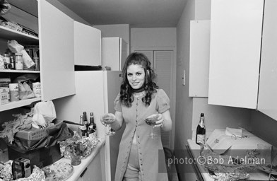 Kitty prepares to serve champagne. - New York City, 1970. photo:©Bob Adelman. From the book Gentleman of Leisure by Susan Hall and Bob Adelman.