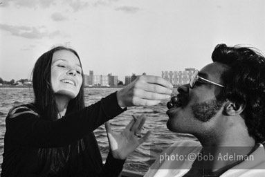 Linda feeds Silky cherries. - New York City, 1970. photo:©Bob Adelman. From the book Gentleman of Leisure by Susan Hall and Bob Adelman.