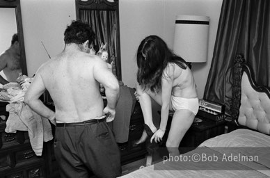 Kitty undresses with a client. - New York City, 1970. photo:©Bob Adelman. From the book Gentleman of Leisure by Susan Hall and Bob Adelman.