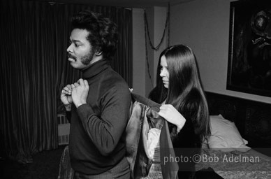Linda puts on Silky's coat. The girls open doors for him, bathe and dress him and roll his reefers. - New York City, 1970. photo:©Bob Adelman. From the book Gentleman of Leisure by Susan Hall and Bob Adelman.