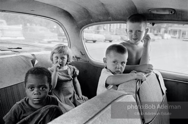 On Main Street,  East Feliciana Parish,  Louisiana  1963-I ran across these children in a car near the Voter Registrar's Office during the Freedom Summer of 1964.  They weren't waiting  for someone who was registering but for a black domestic to finish the family's shopping.