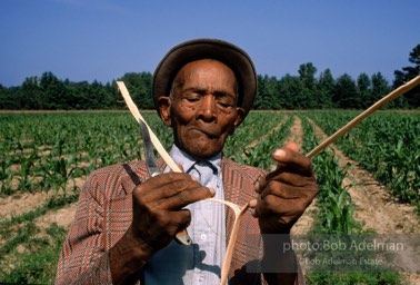 Ben Jones splits a tree limb into strips, then weaves a basket,  Demopolis,  Alabama  1983