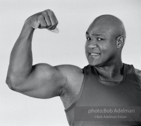The Champ: heavyweight boxing champion George Foreman, New York City.  1995


“During a break, Foreman told me that he was saved by a ‘benevolent society.’ He had been
doing poorly in school and was getting into trouble. Fearing police were looking for him,
he hid under his family’s home and covered himself in sand, breathing through a straw.
There had to be a better way. His salvation was a government-sponsored anti-poverty
boxing program, the Job Corps, that led to his Olympic gold medal and eventually the World Championship.