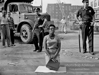 Stop action: Determined to end unfair hiring practices, two protestors put their lives on the line, closing down a construction site at the Downstate Medical Center, Brooklyn, New York City. 1963