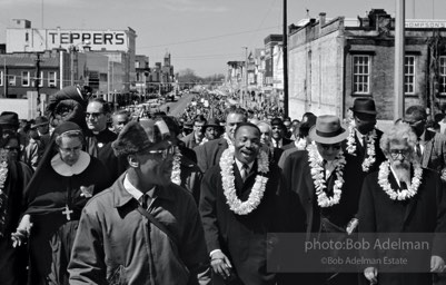 Crossing over: King leads the Montgomery-bound marchers over the Edmund Pettus Bridge, which was already famous for shocking scenes of police brutality,   Selma,  Alabama.  1965