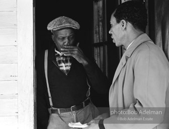 A candidate ponders what he’s hearing as voter-registration organizer Frank Robinson offers assistance,  Sumter,  South Carolina.  1962