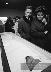 With Allah: Sheathed in accordance with Islamic tradition, the slain martyr is viewed by thousands, Harlem, New York City.   1965