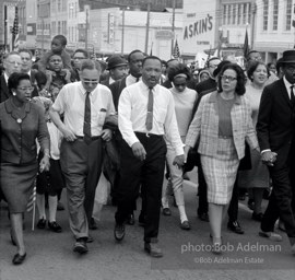 Leading a throng of 25,000 marchers, King enters the downtown, Montgomery, Alabama.  1965